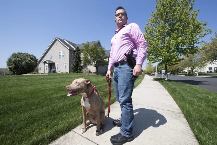 Mark Fiorino is photographed with an open-carry handgun during a walk with his dog &quot; Barrett &quot; in Allentown, Pa. Wednesday, May 9, 2018.