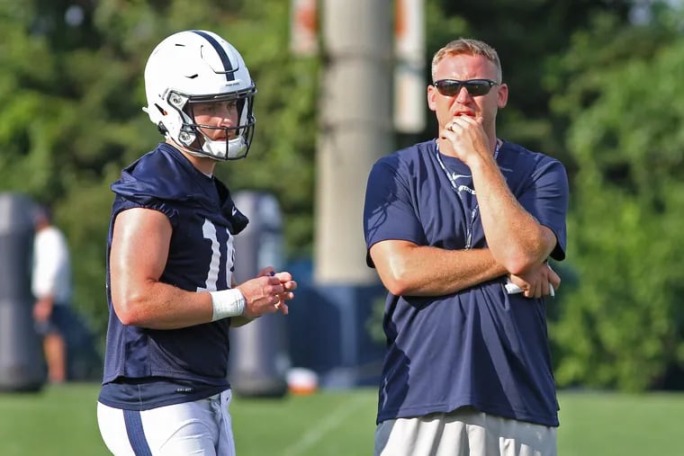 Penn State quarterback Sean Clifford with offensive coordinator Ricky Rahne during a preseason practice. CRAIG HOUTZ