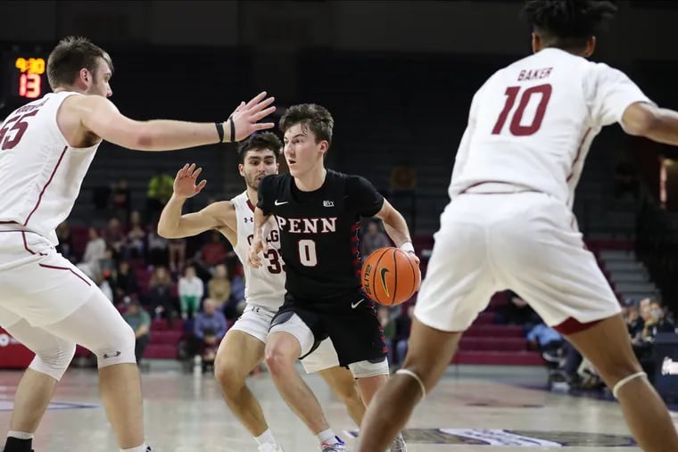 Clark Slajchert (center) of Penn drives through Colgate defenders during the second half during the Cathedral Classic at the Palestra on Nov. 26.