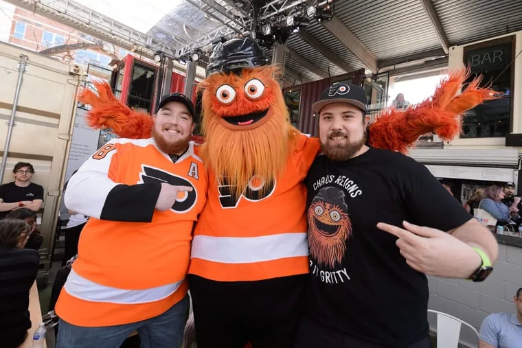 Fans pose with Gritty at the Comcast NBCUniversal House Saturday at the South by Southwest festival in Austin, Texas.
