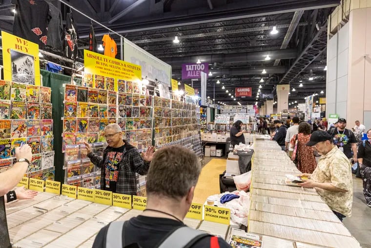 Ruben Miranda, 56, of New York City, and a salesman at Absolute Comics & Statues, talks with guests as they look for comics at the 2024 Comic Book Fan Expo at the Pennsylvania Convention Center in Philadelphia on Friday, May 3, 2024.