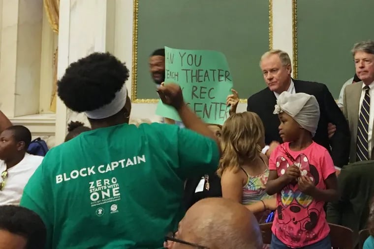 State Sen. Scott Wagner speaks with protesters disrupting his Local Government Committee hearing in City Hall.