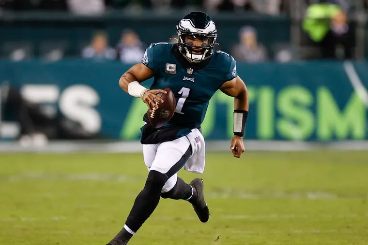 Eagles quarterback Jalen Hurts finds room to run against the Chargers.