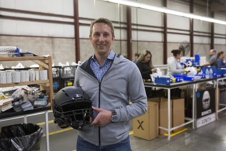 President of Xenith, Ryan Sullivan, poses for a portrait with a helmet at the Xenith factory in Detroit.