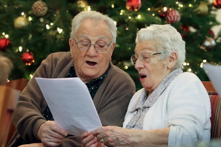 Michael and Louise Conti, Spring Mill residents, are also members of the choir. They were rehearsing recently for their holiday concert.