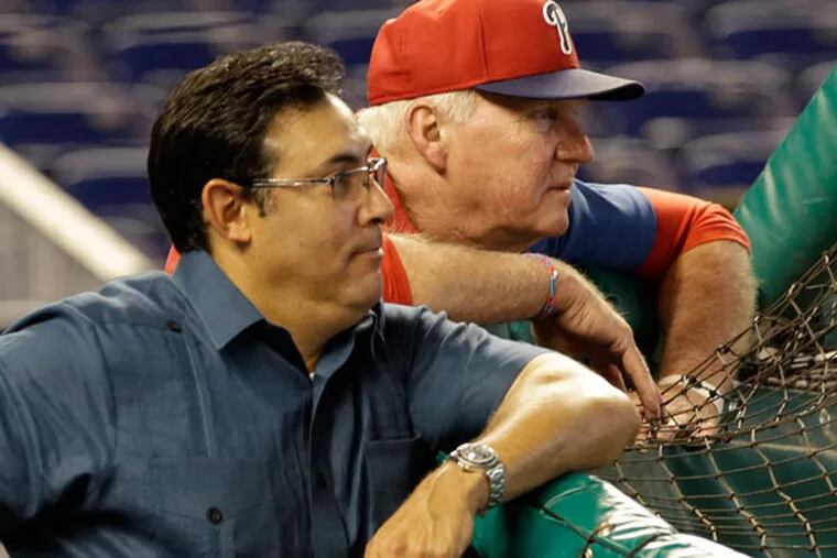 Philadelphia Phillies manager Charlie Manuel, right, and general manager Ruben Amaro, Jr. watch batting practice before an MLB baseball game against the Miami Marlins in Miami, Saturday, April 13, 2013. (Alan Diaz/AP)