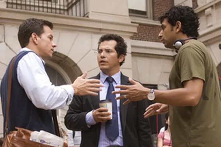 On location for &quot;The Happening,&quot; Shyamalan reviews a scene with Mark Wahlberg (left) and John Leguizamo.