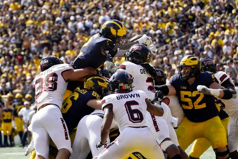 Michigan running back Blake Corum (2) dives for a one-yard touchdown run against Northern Illinois in the second half of a NCAA college football game in Ann Arbor, Mich., Saturday, Sept. 18, 2021. (AP Photo/Paul Sancya)