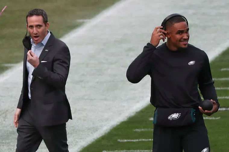 Eagles quarterback Jalen Hurts (2) walks away after a conversation with GM Howie Roseman before a game against the New Orleans Saints at Lincoln Financial Field in South Philadelphia on Sunday, Dec. 13, 2020. Hurts is getting the start over Carson Wentz today.