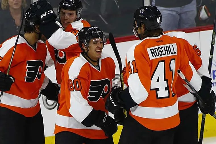 Flyers center Travis Konecny (80) celebrates his second period goal with teammates defenseman Michael Del Zotto (15), defenseman Yevgeni Medvedev (82) of Russia and left winger Jay Rosehill (41) during an NHL preseason hockey game against the New York Islanders in Allentown, Pa., Monday, Sept. 21, 2015.