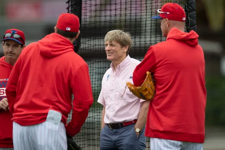 Phillies majority owner John Middleton (middle) is willing to spend big money to make the team better. Not many other baseball owners appear to feel the same way.