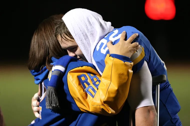 Sean Pelkisson, right, of Downingtown West is hugged after their loss to Central Dauphin in the PIAA Class 6A semifinals on Nov. 29, 2019.