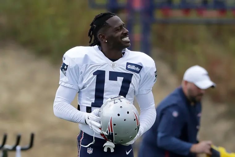 New England Patriots wide receiver Antonio Brown carries his helmet during a practice.