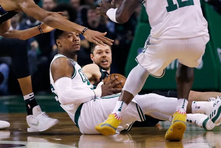 Boston Celtics guard Marcus Smart looks to pass as he recovers a loose ball during the first quarter during Game 5 of the Celtics-Bucks series.