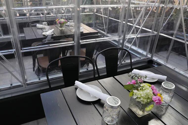 Mini greenhouses are set up for isolated seating as the weather cools at Harper's Garden in Center City Philadelphia on Thursday, Oct. 8, 2020.