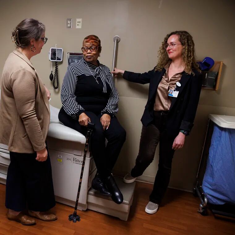 Patient Linda Brothers, center, poses for a portrait with physician assistant Amanda McClendon and physician Mara Caroline in an exam room at Lankenau Hospital in Wynnewood. The Lankenau Initiative to Improve Cardiovascular Access program has been serving heart attack patients like Brothers for about a year.