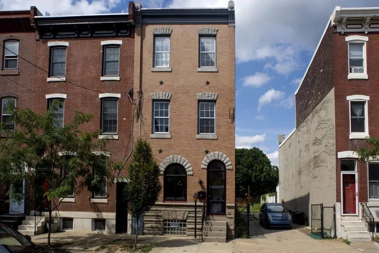 The environmentally sensitive home (center) and empty lot (to the right) of Peter Angevine and Maura DiBerardinis in Fishtown. The former front &quot;door&quot; is now a window to let more light into the house.