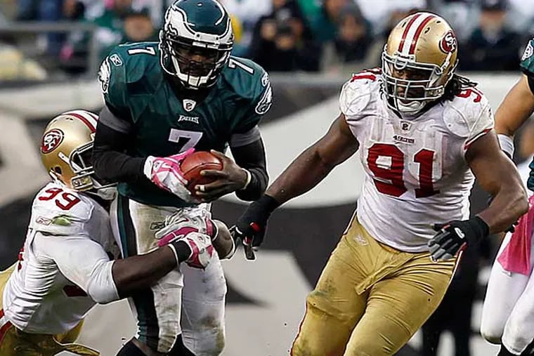 Michael Vick (7) is tackled by San Francisco 49ers linebacker Aldon Smith (99) in the second half of an NFL football game Sunday, Oct. 2, 2011 in Philadelphia. (Alex Brandon/AP)