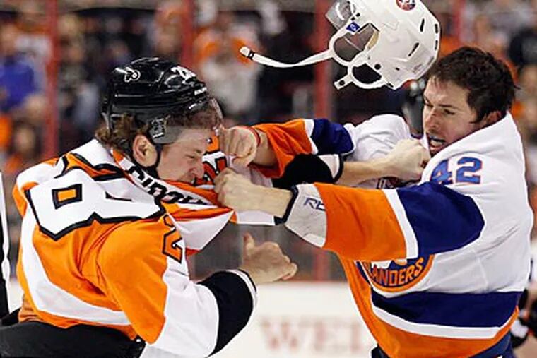 Flyers center Claude Giroux and the Islanders' Dylan Reese fight during the second period on Thursday. (Yong Kim/Staff Photographer)