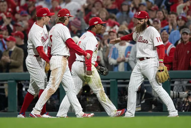 Phillies second baseman Jean Segura, center, reacts after making a play to end the top of the seventh inning of Game 3 on Friday.