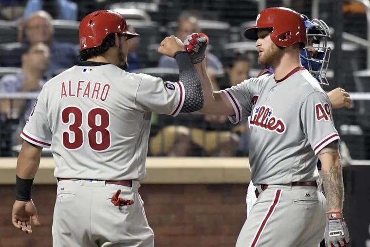 Phillies starter Ben Lively celebrates with Jorge Alfaro after hitting a two-run homer during the fourth inning against Mets.