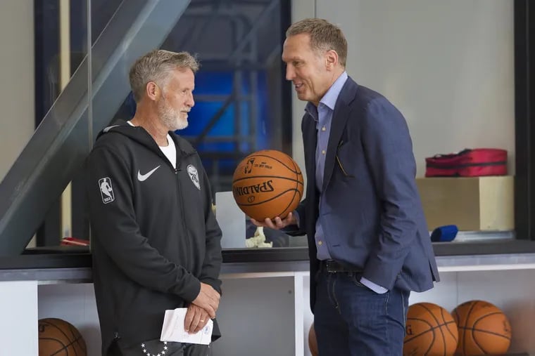 Bryan Colangelo, right, talking with coach Brett Brown after a September practice. 