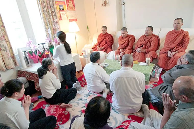 A Buddhist memorial service for Don Ly is held inside the Ly family home after the vigil in South Philadelphia on April 18, 2014.  (ELIZABETH ROBERTSON / Staff Photographer)