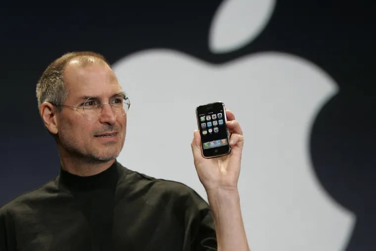 Apple cofounder Steve Jobs holds up the new iPhone during his keynote address at MacWorld Conference & Expo in San Francisco in 2007.