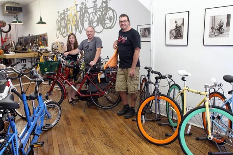 Owners of the Firth & Wilson Transport Cycles (l-r): Victoria Firth, Simon Firth and David Wilson inside their custom bike shop on 933 of Spring Garden St., on Monday August 5, 2013.  The bike shop specializes in city and cargo bikes.  ( Yong Kim / Staff Photographer )