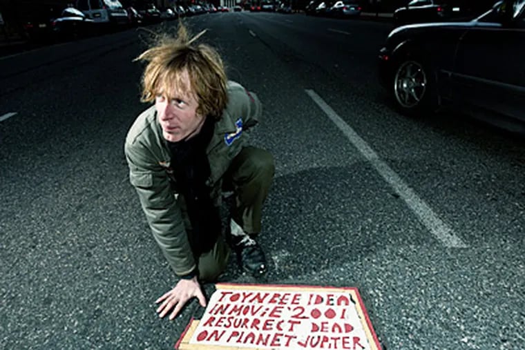 Justin Duerr with a Toynbee tile in a scene from &quot;Resurrect Dead: The Mystery of the Toynbee Tiles.&quot; Duerr has been probing the case for years.