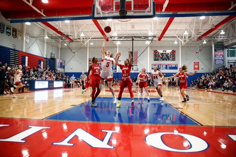 Plymouth Whitemarsh guard Kaitlyn Flanagan drives in for a layup between Upper Dublin defenders Jackie Vargas (42) and Anajae Smith (5) during the fourth quarter of a District 1 Class 6A basketball quarterfinal Saturday, Feb. 22, 2020 in Plymouth Meeting.Â PW went on to win, 35-21.