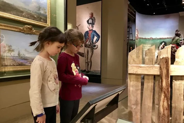 Addie (left) and Felicity Smith visit the Museum of the American Revolution, where Felicity read exhibit descriptions to her sister.