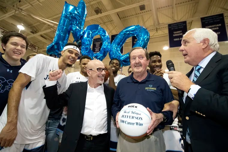 Coach Herb Magee of Jefferson University is congratulated  by DeVaughn Mallory, 2nd from left, and University President Stephen Klasko, center, after getting win number 1100 against Kutztown on Nov. 19, 2019.