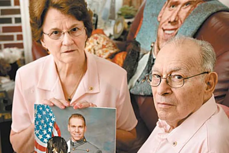 Trudy and Sal Corma of Gloucester County with a photo of their son, Army First Lt. Salvatore Corma III, who was killed by a mine in Afghanistan. (LAURENCE KESTERSON / Staff Photographer)