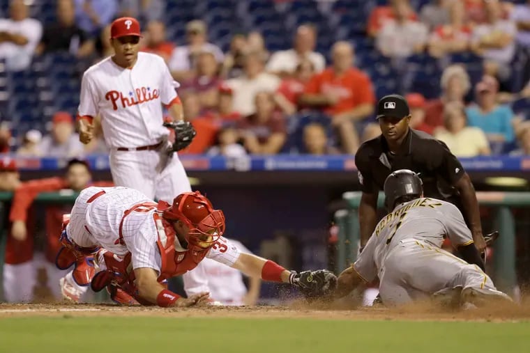 Sean Rodriguez tries to avoid a tag from A.J. Ellis at the plate when the Pirates played the Phillies back in 2016. (YONG KIM / Staff Photographer)