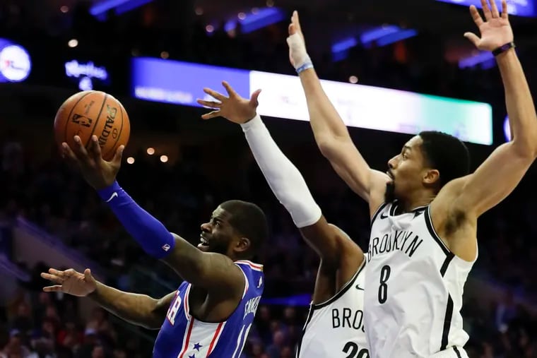 Sixers forward James Ennis III lays-up the basketball against Brooklyn Nets guard Caris LeVert (center) and guard Spencer Dinwiddie in game two of the Eastern Conference playoffs on Monday, April 15, 2019 in Philadelphia.