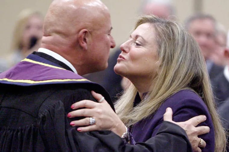 McCaffery and wife Lise Rapaport kiss after he was sworn in as justice. He stepped down in October, and Rapaport, who was her husband's aide for 17 years, also retired. (ELIZABETH ROBERTSON / Staff Photographer)
