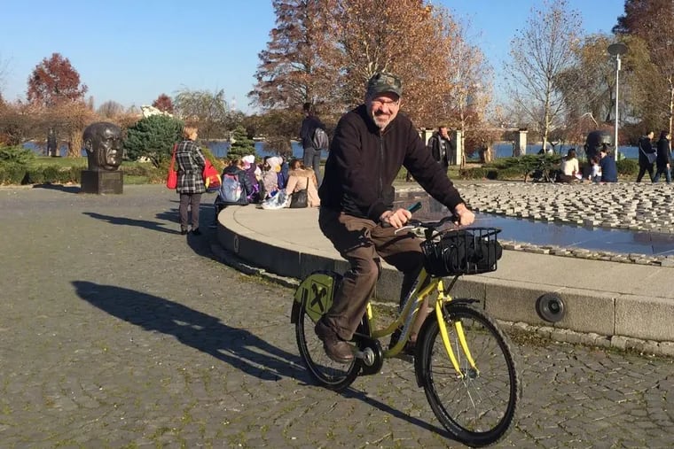 Michael Milne takes a break from dental work to bicycle through Bucharest's Herastrau Park.