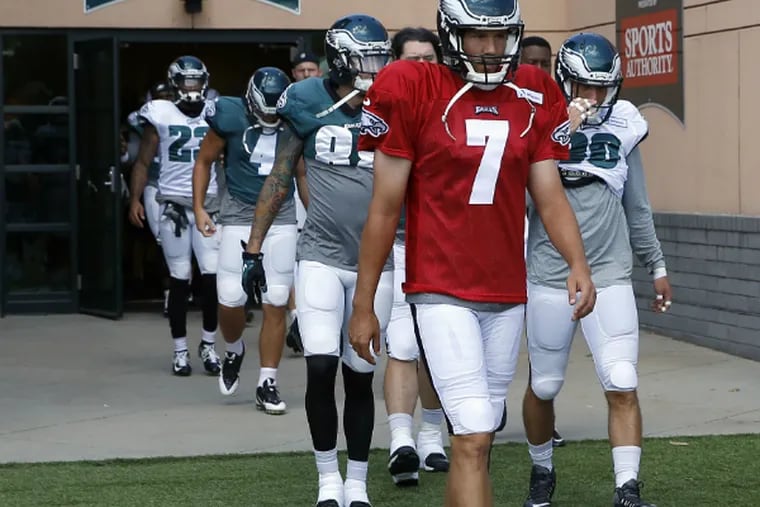 Sam Bradford leads the Eagles onto the practice field during training camp yesterday.