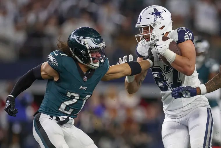 Eagles safety Sydney Brown tries to bring down Dallas Cowboys tight end Jake Ferguson during Sunday's game at AT&T Stadium.