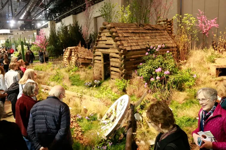 Visitors to the Philadelphia Flower Show take in one of the main exhibits, "After the Encampment" by Hunter Hayes Landscape Designs. The portrayal of Valley Forge fits in with the show's homage to the National Park Service's 100th anniversary. The Flower Show, which opened Saturday, runs through next Sunday.