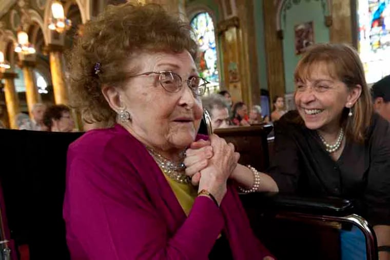 Polish immigrants who still live in the Whitman Park section of Camden, NJ  that used to be known as Pollocktown, photographed in September, 2013.  Here at St. Joseph's church, Kazimiera Olejnik celebrates her 100th birthday, with an assist from daughter Barbara Olejnik.  ( APRIL SAUL / Staff )
