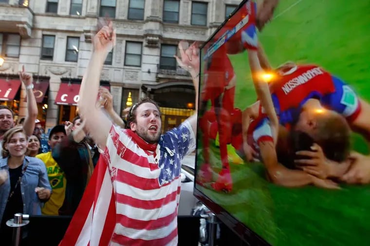 American soccer fans in Center City cheer the 2-1 U.S. win over Ghana in the 2014 World Cup - the year's second most-searched topic. (YONG KIM / Staff Photographer)