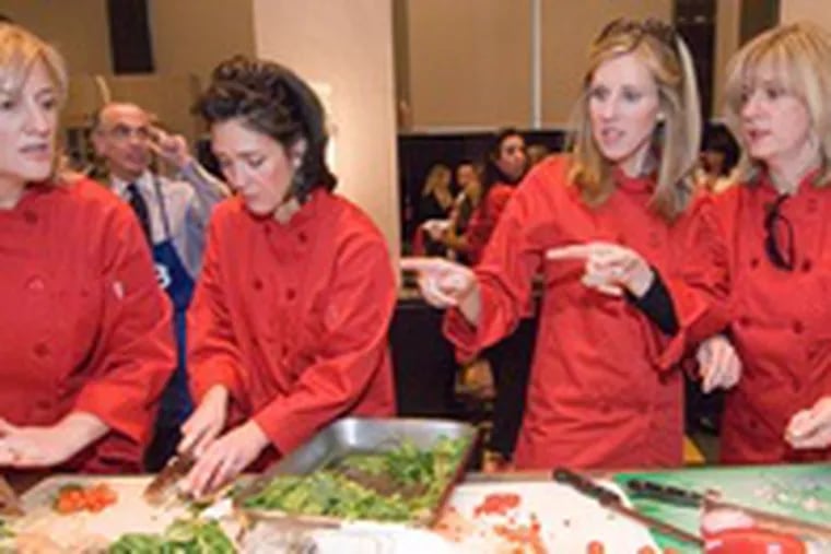Teammates getting their meal ready are, from left: Kim Cilio, Susan Lipson of Philadelphia Magazine, Barbara Barnhart, Jull Dorvsik, Project H.O.M.E. supporters.