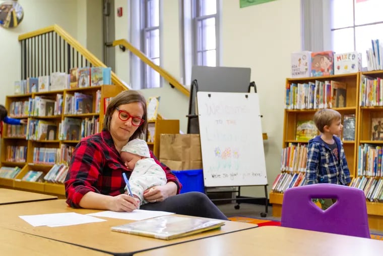 Beth Underwood holds her baby, Gertrude, in the Queen Memorial Branch of the Free Library of Philadelphia, in Queen Village, Philadelphia PA, Sunday, March 5, 2019. For the third straight year, President Trump has proposed to virtually eliminate federal funding for libraries.