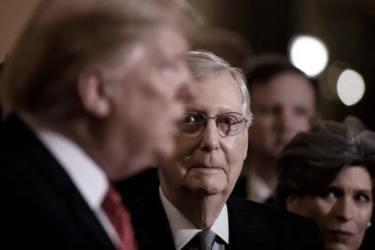 U.S. President Donald Trump, left, talks to the press as Senate Majority Leader Mitch McConnell (R-Ky.) looks on after the Republican luncheon at the U.S. Capitol Building on Wednesday, Jan. 9, 2019 in Washington, D.C.