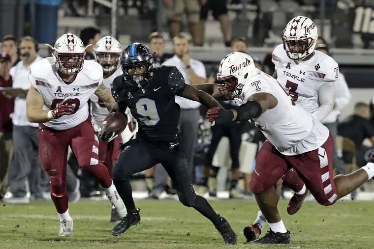 Central Florida running back Adrian Killins Jr. (9) runs past the Temple defense during the second half of an NCAA college football game, Thursday, Nov. 1, 2018, in Orlando, Fla. (AP Photo/John Raoux)