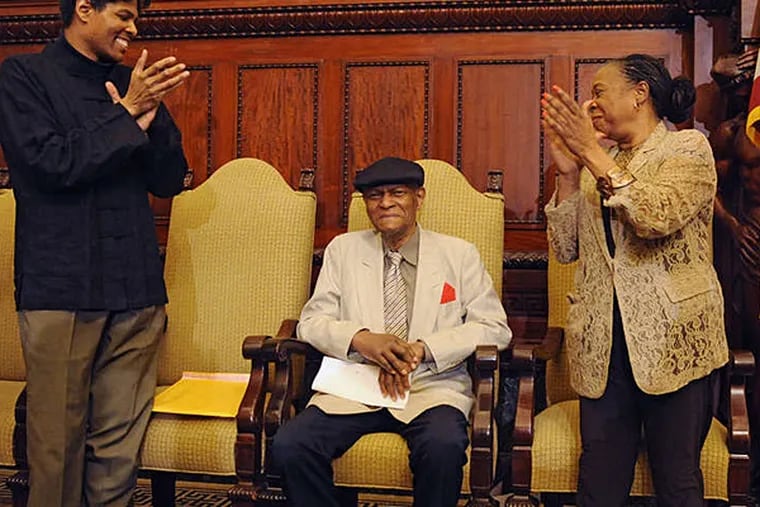 McCoy Tyner ( center) is applauded by his son Nurudeen Tyner (left) and Helen Haynes of the Office of Arts, Culture and the Creative Economy at City Hall. (CLEM MURRAY / Staff Photographer)