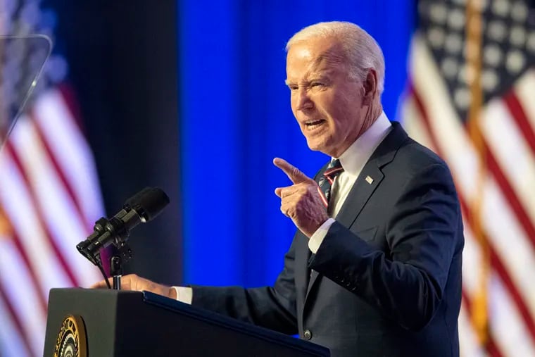 President Joe Biden speaks at the podium at the Montgomery County College in Blue Bell Friday, Jan. 5, 2024, a day ahead of the third anniversary of the Jan. 6 attack.