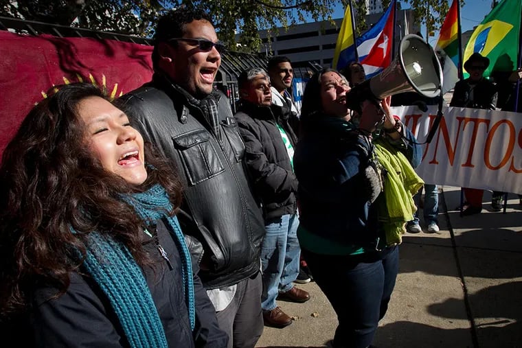 Juntos members (from left) Olivia Vasquez, Miguel Andrade and Erika Almiron during a rally outside immigration offices at North 16th and Callowhill streets on Friday, November 21, 2014. ( ALEJANDRO A. ALVAREZ / STAFF PHOTOGRAPHER )